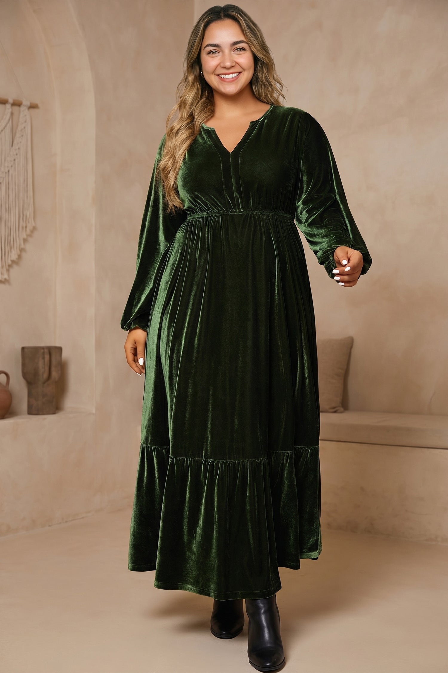 Woman in plus size green velvet V neck maxi dress with balloon sleeves and empire waist