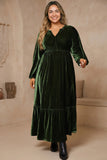 Woman in plus size green velvet V neck maxi dress with balloon sleeves and empire waist