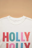 Close-up of red, blue and pink gingham Holly Jolly letters on a white sweatshirt