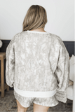 Back view of woman in gray-white patterned lounge set with white waistband.