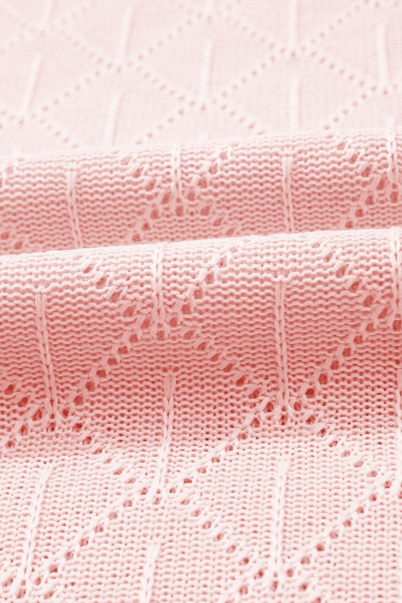 Close-up of pink textured fabric with a subtle pattern