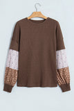 Coffee waffle knit top with floral patchwork sleeves on a hanger, front view