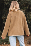 Person wearing a brown fleece jacket in a natural setting