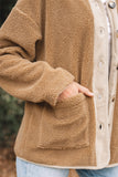 Close-up of a brown fleece jacket with a blurred natural background