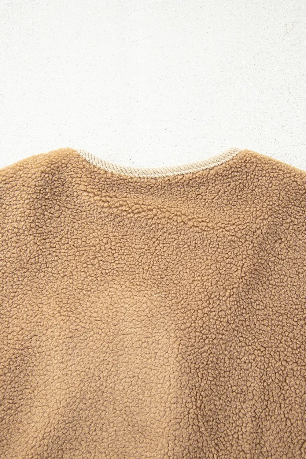 Close-up of a textured beige fabric on a white background