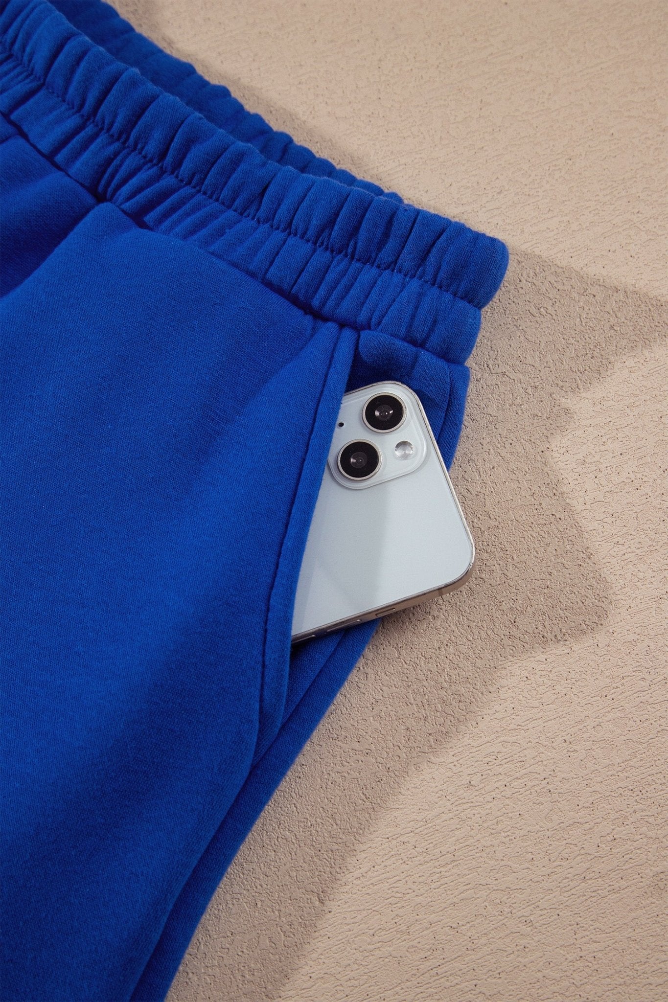 Royal blue athletic shorts with elastic waistband & white-blue polka-dot trim along the hem.
