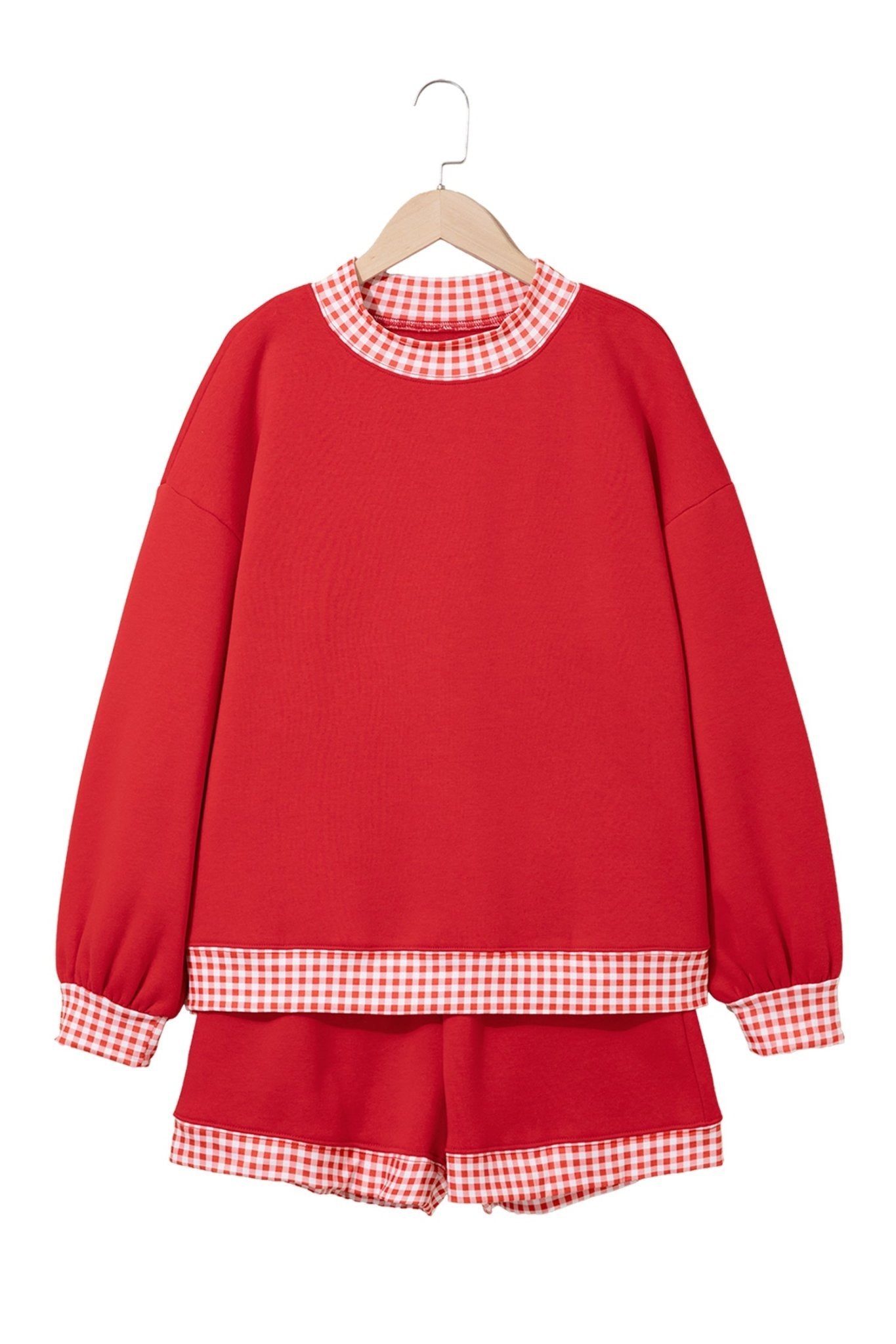 Red sweatshirt and matching shorts set with red-white gingham trim, relaxed balloon sleeves, on hanger.