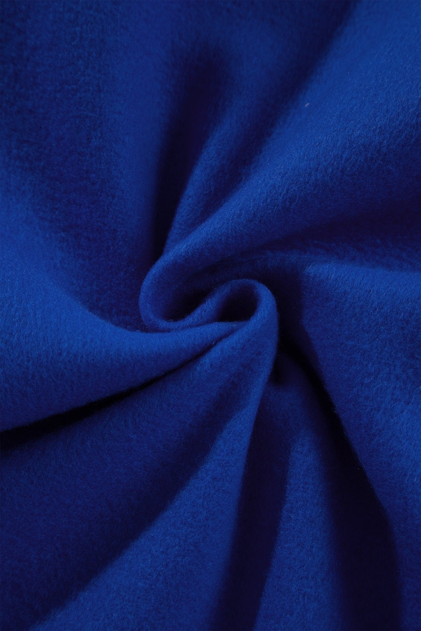 A close-up of a vibrant royal blue fabric, elegantly swirled in the center to showcase its soft texture and drape.