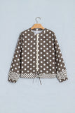 A brown and white polka dot jacket with a drawstring front