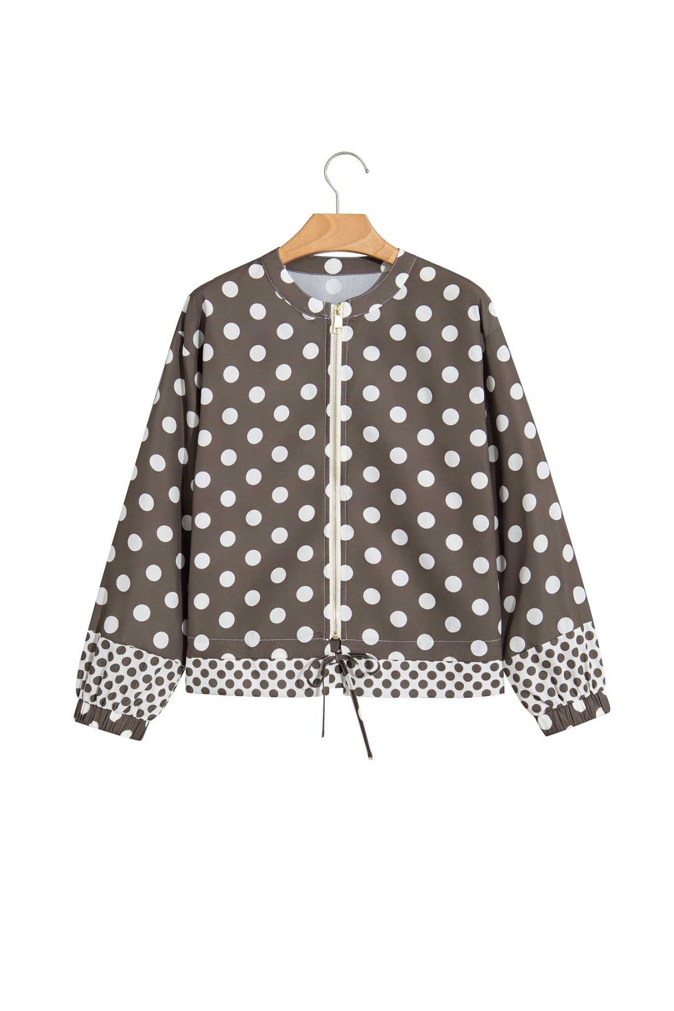 A brown long-sleeve blouse with a white polka dot pattern, featuring a drawstring waist
