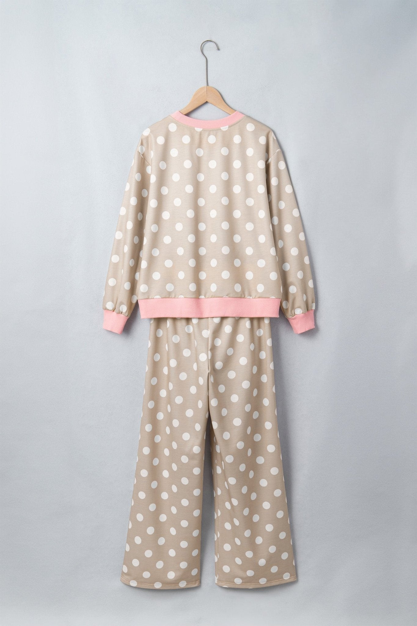 Beige polka-dot pajama set with pink ribbed trim, featuring a top and wide-leg pants.