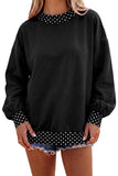 Black colorblock sweatshirt with polka dot neckline, cuffs and hem, styled with denim shorts