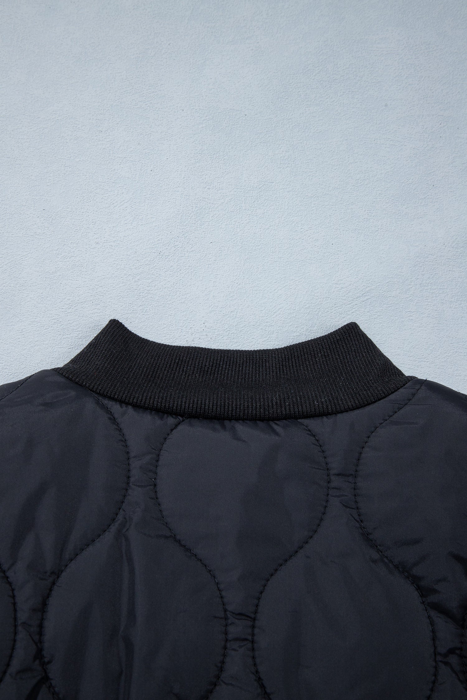 Black quilted jacket ribbed back collar detail