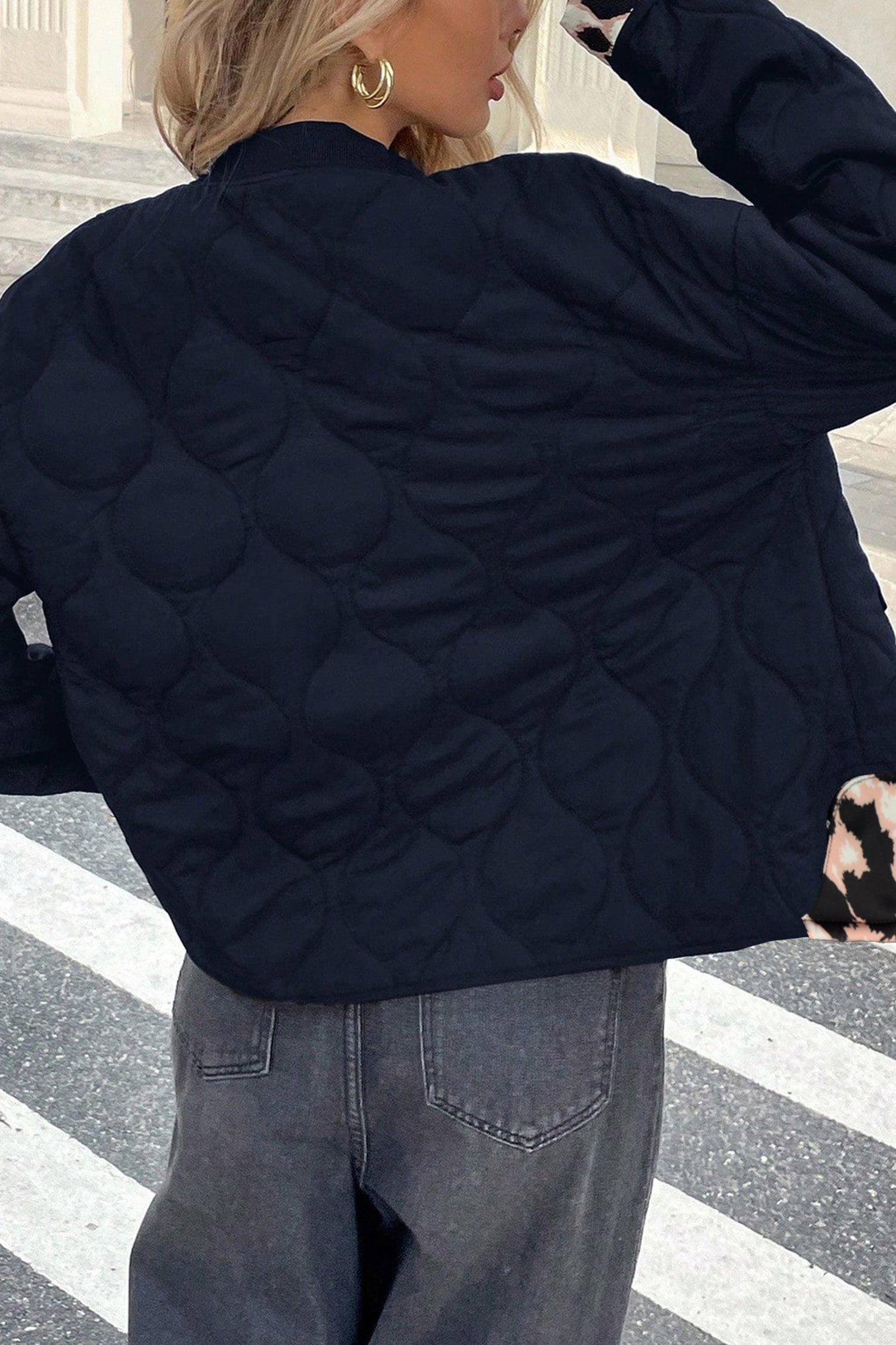 Black wavy quilted puffer jacket with ribbed collar, back view