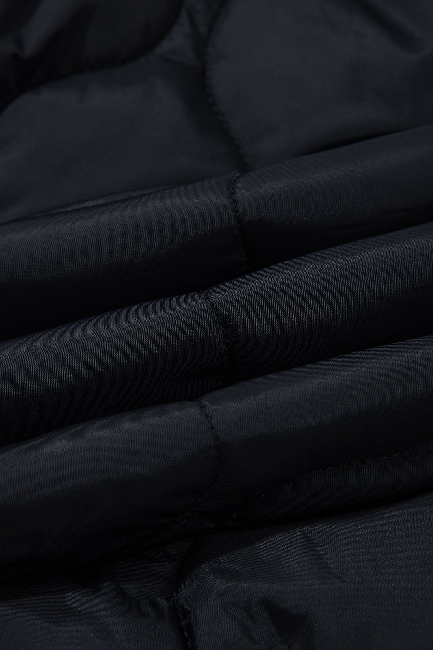 Close-up of black wavy quilted puffer fabric