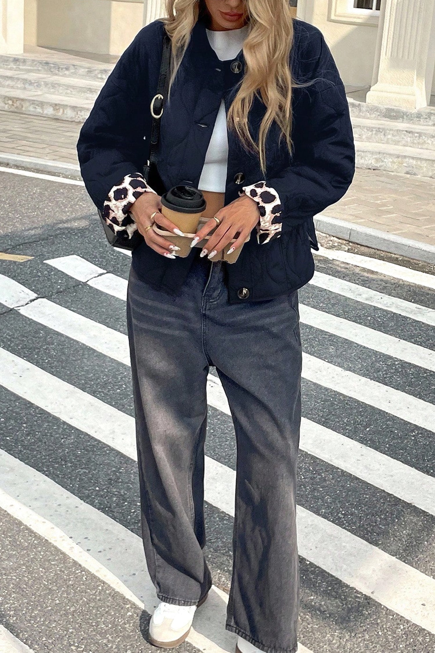 Black quilted button front jacket with leopard cuffs and wide leg jeans, full length