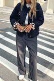 Black quilted button front jacket with leopard cuffs and wide leg jeans, full length