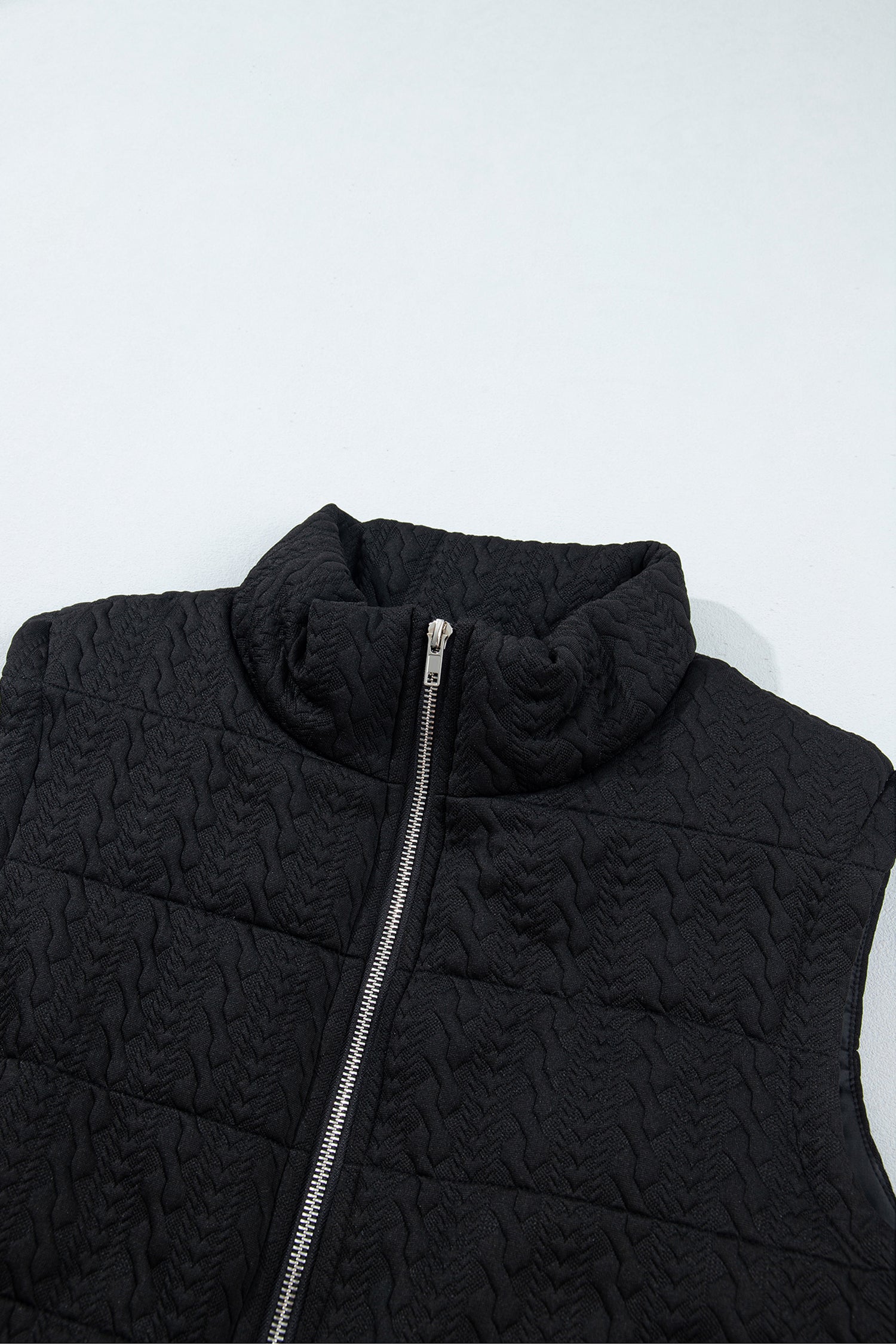 Black quilted vest high stand collar and silver zipper detail