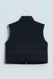 Black quilted zip up vest on a hanger, back view