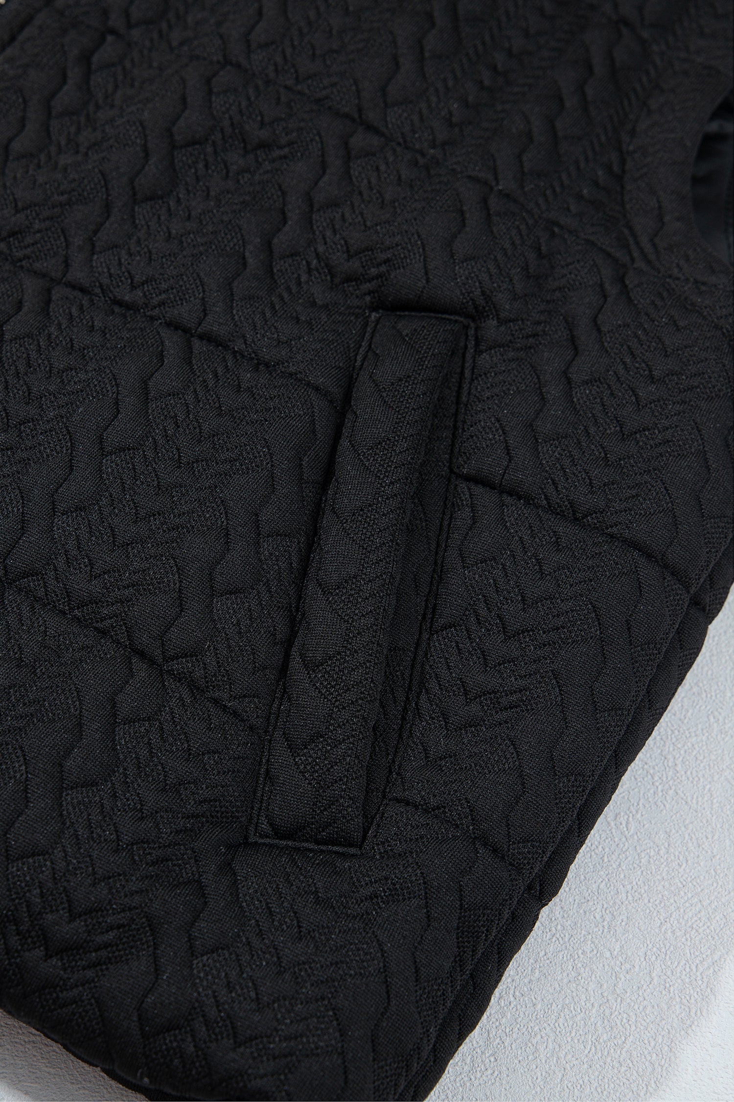 Black quilted puffer vest welt pocket detail