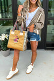 Woman holding a decorative handbag outdoors