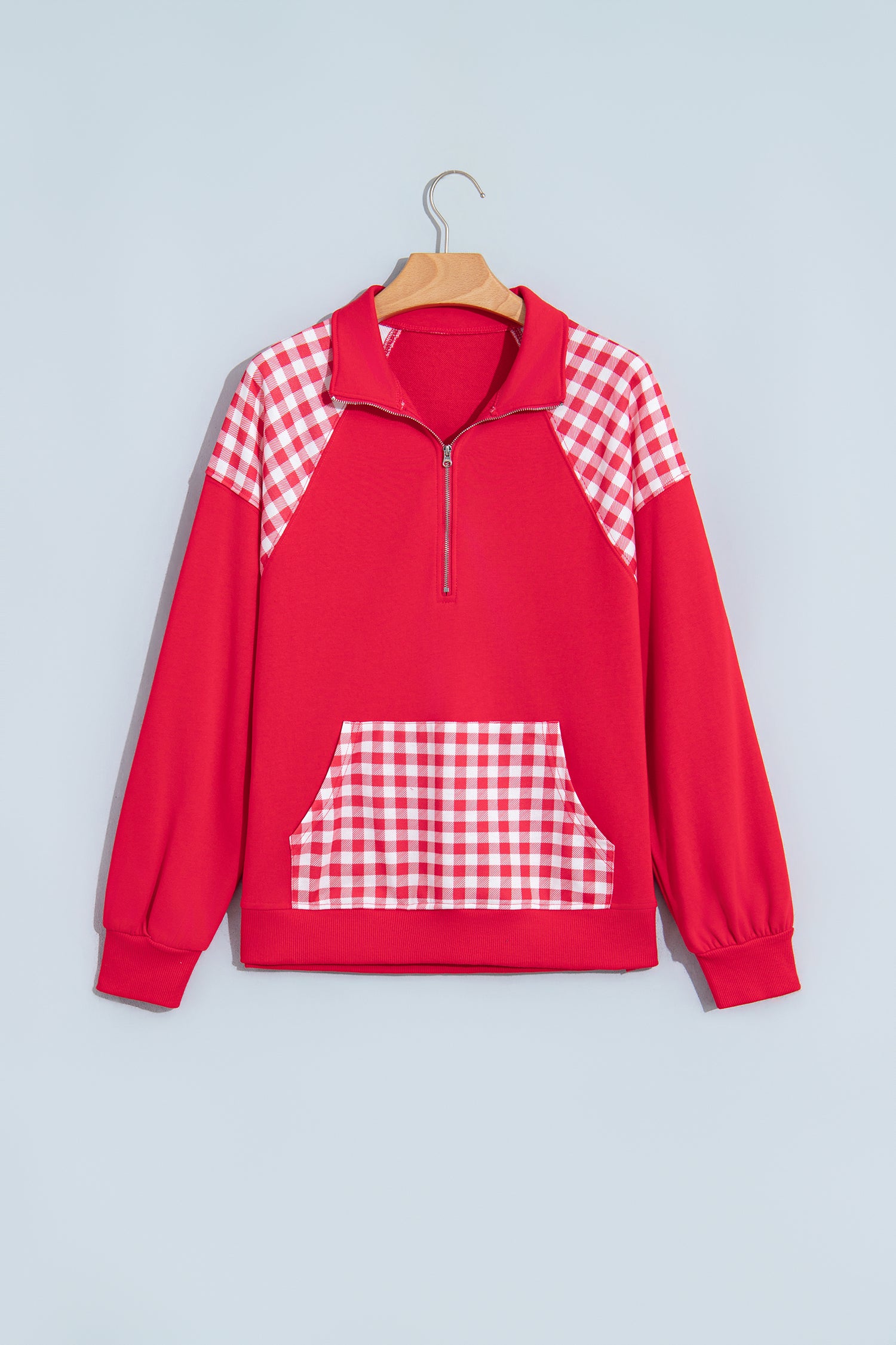 Racing red plaid quarter zip sweatshirt on hanger, front view