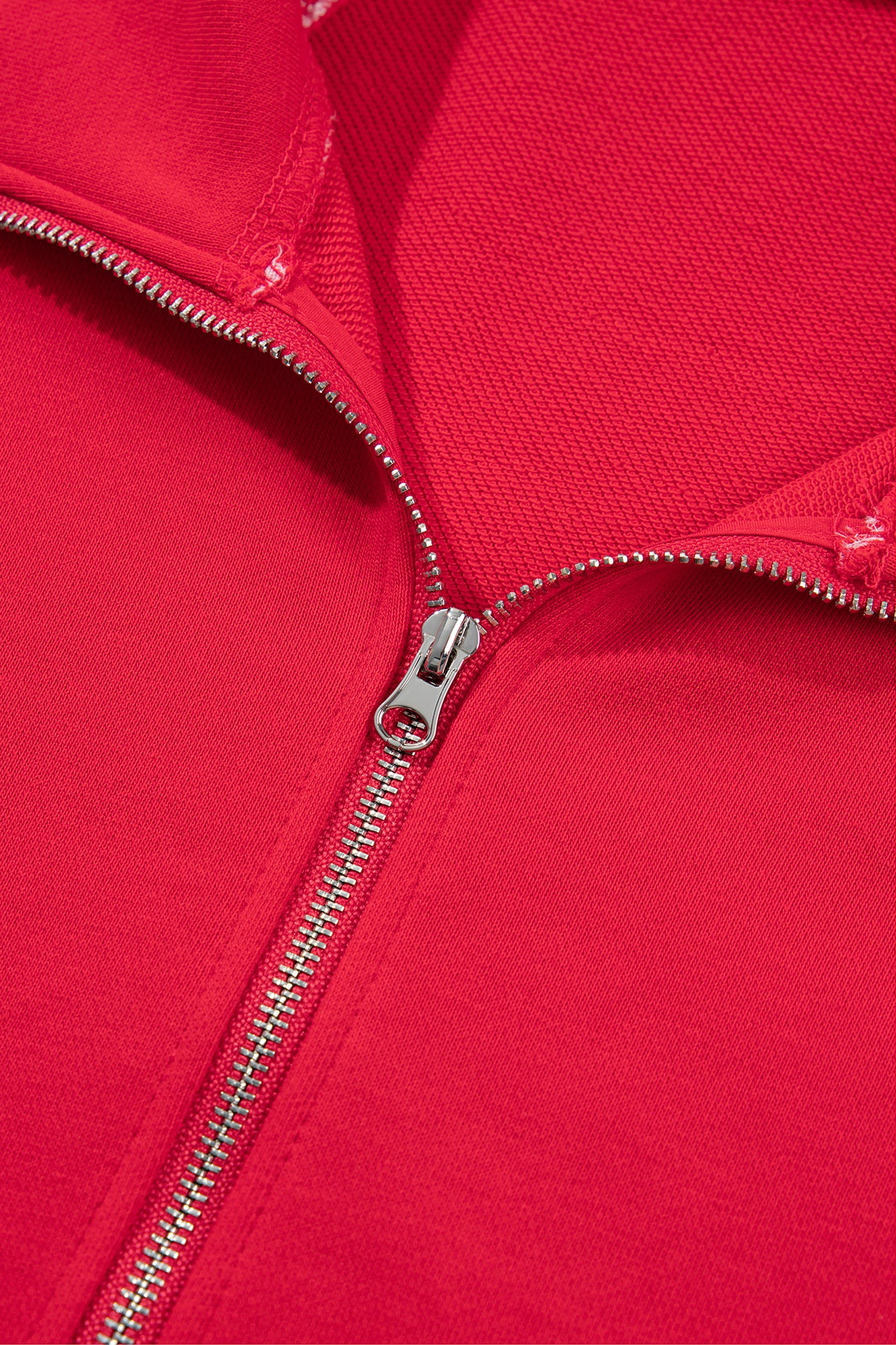 Racing red quarter zip sweatshirt metal zipper, close-up