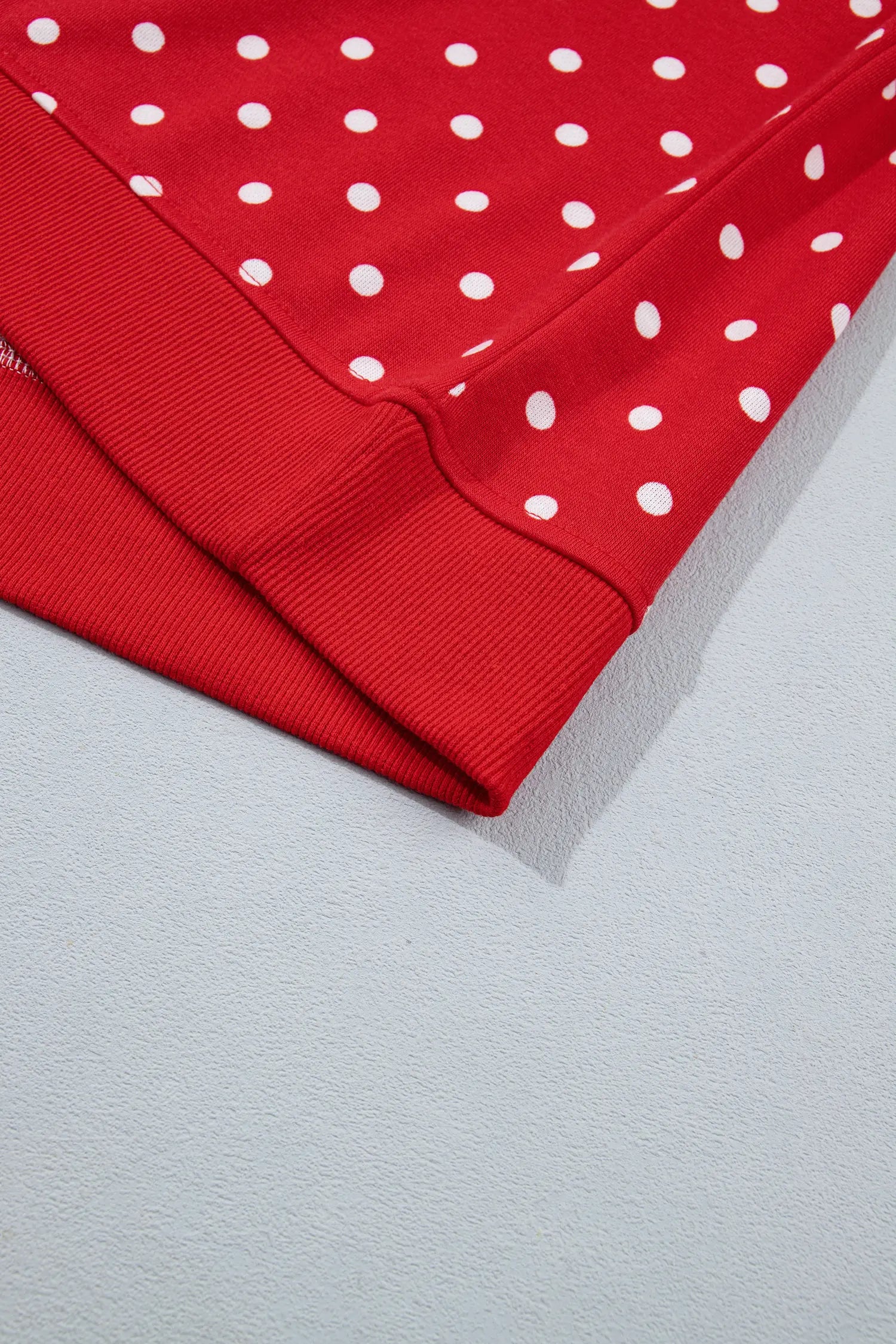 Ribbed cuff on the red polka dot balloon sleeve top
