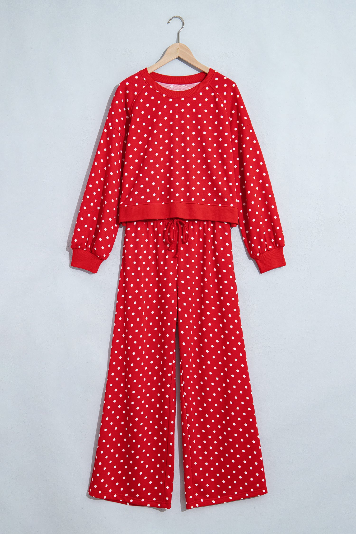 Red polka dot top and wide leg pant set on a hanger, front view