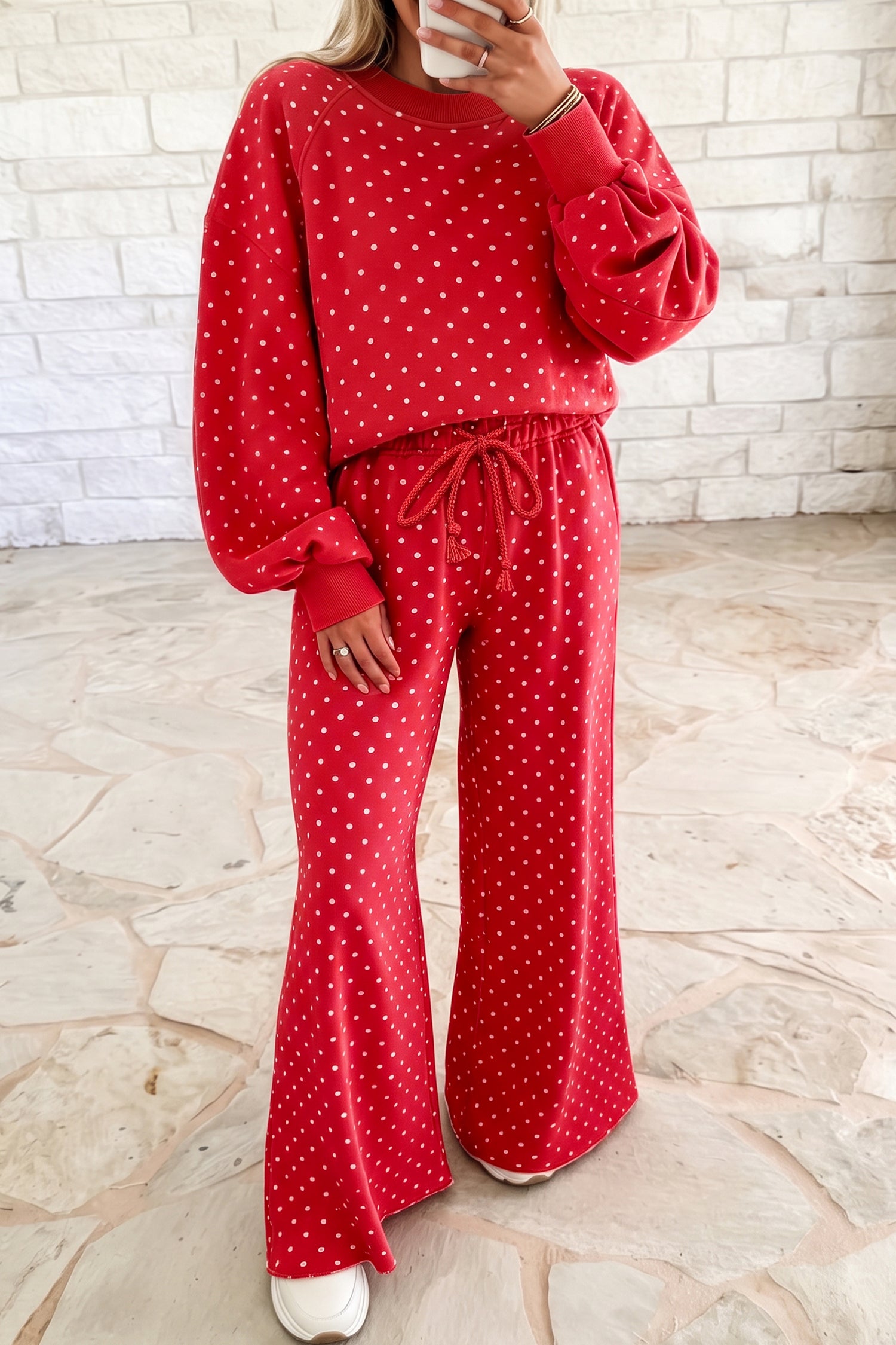 Woman wearing a red polka dot top and drawstring wide leg pant set