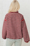 Back view of red striped sherpa pullover with red piping at shoulders and hem