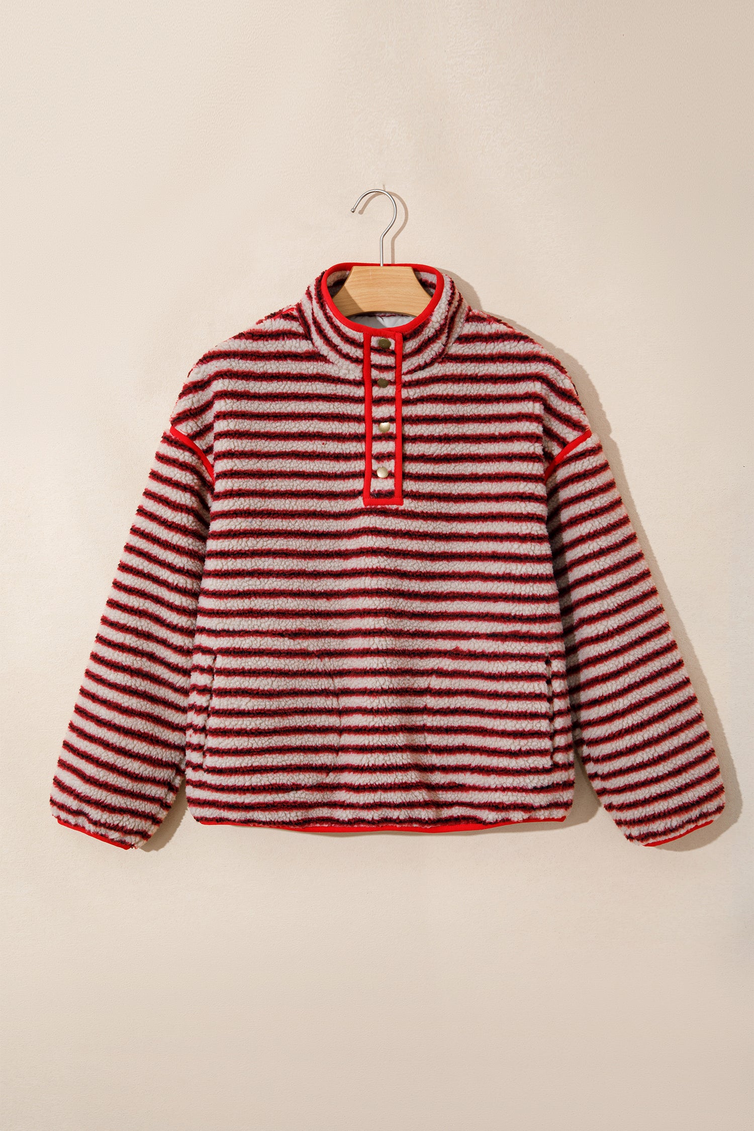 Red striped sherpa snap button stand collar pullover on a hanger, front view