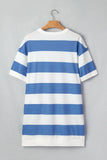 Blue and white striped dress on a hanger against a gray background