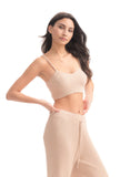 Woman wearing a beige ribbed two-piece set on a white background