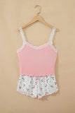 Light pink camisole with white lace trim and floral-print shorts on a hanger.