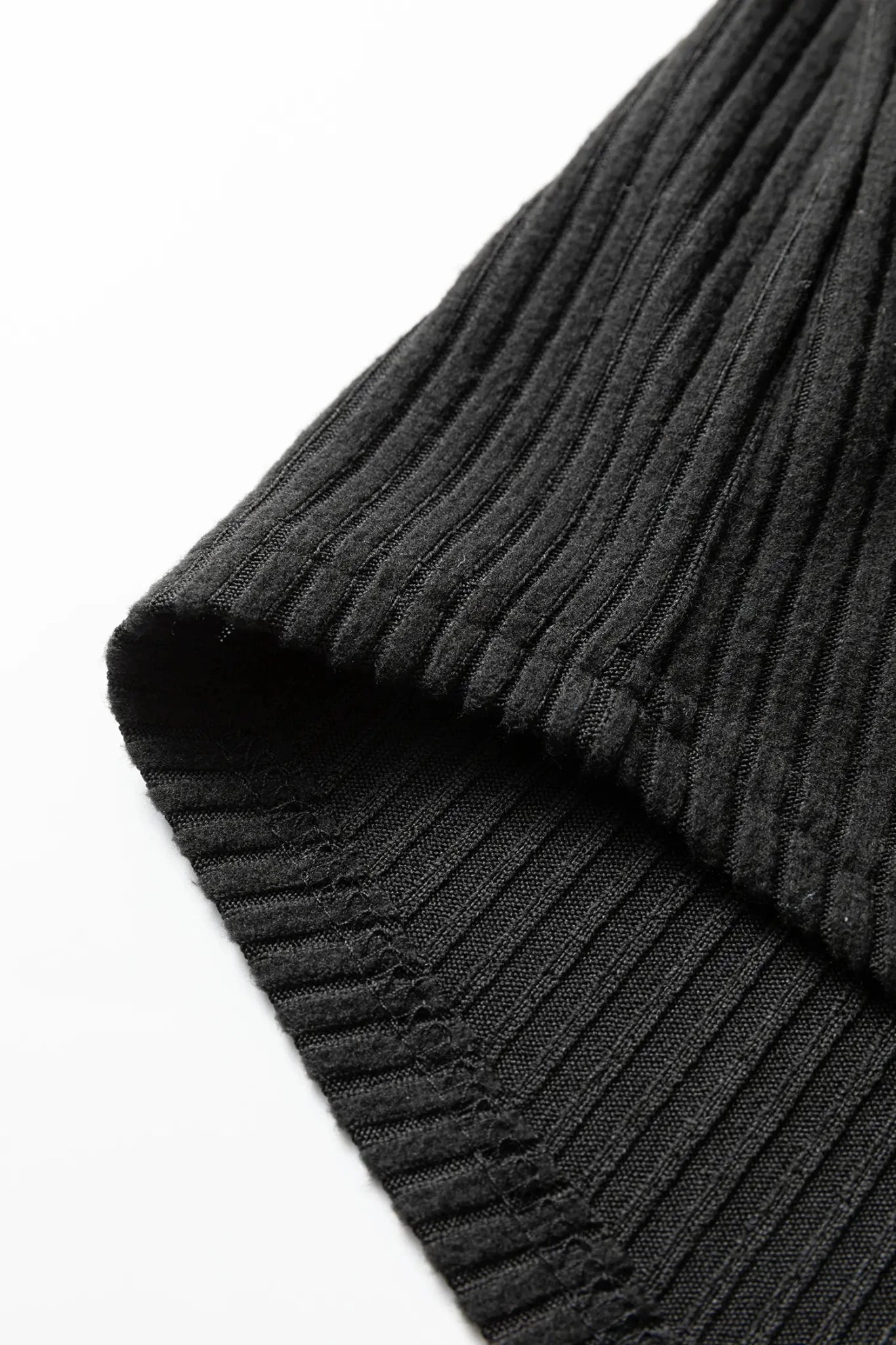 Close-up of a dark gray knitted fabric on a white background