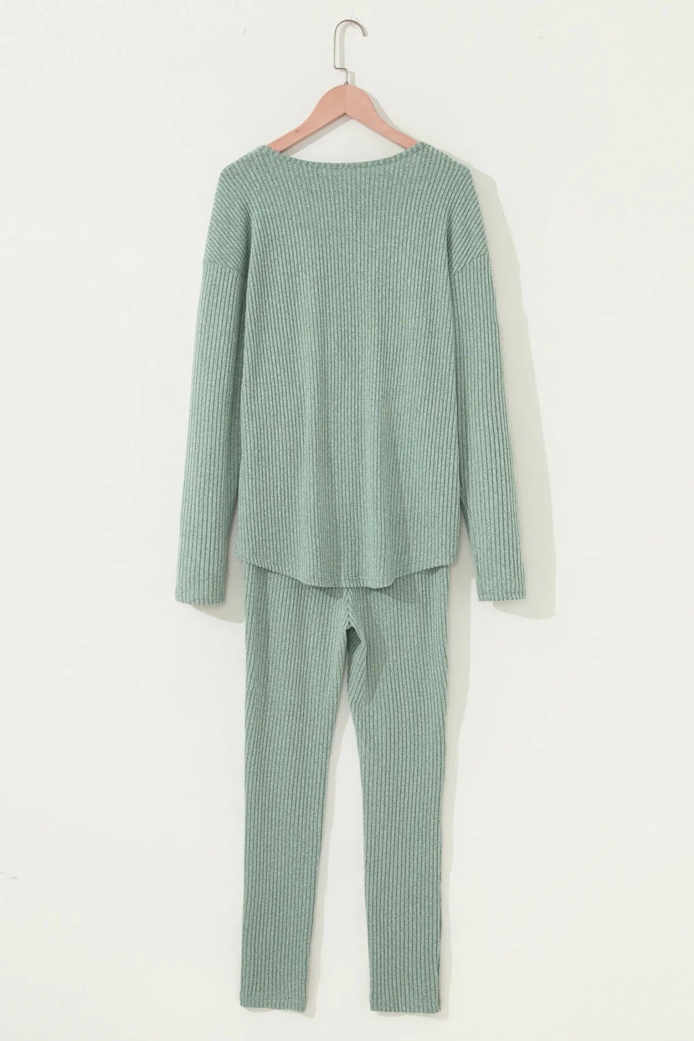 Sage green ribbed knit loungewear set with long-sleeve top and pants.
