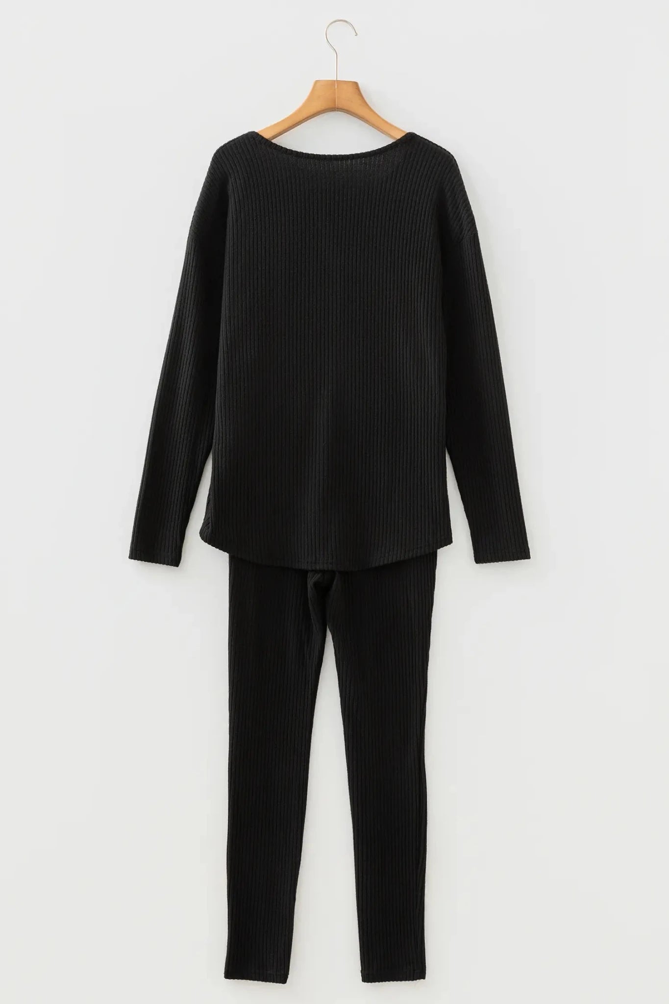 Black ribbed knit loungewear set with long-sleeve top and matching pants.