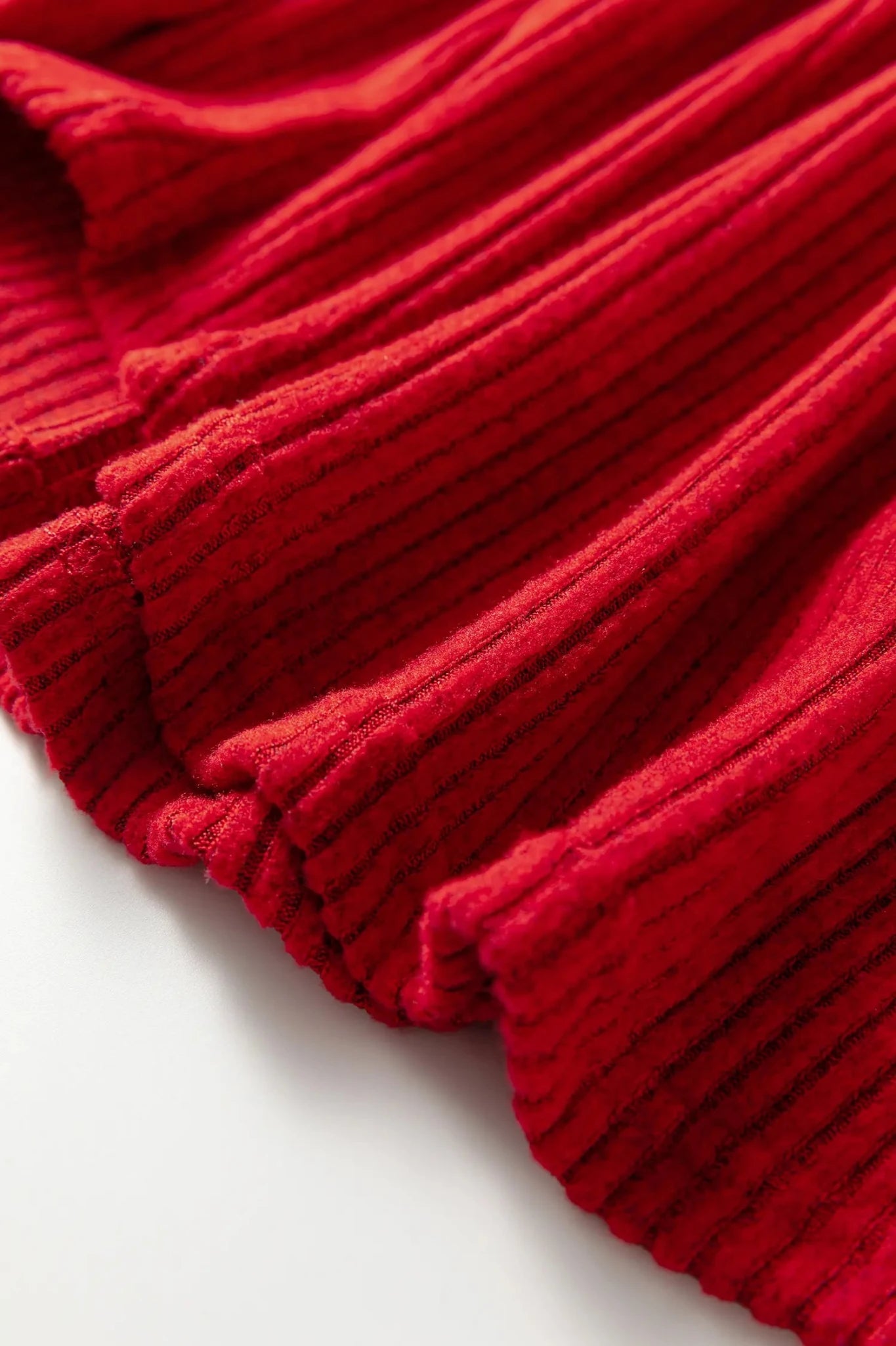 Close-up of a red textured fabric on a white background