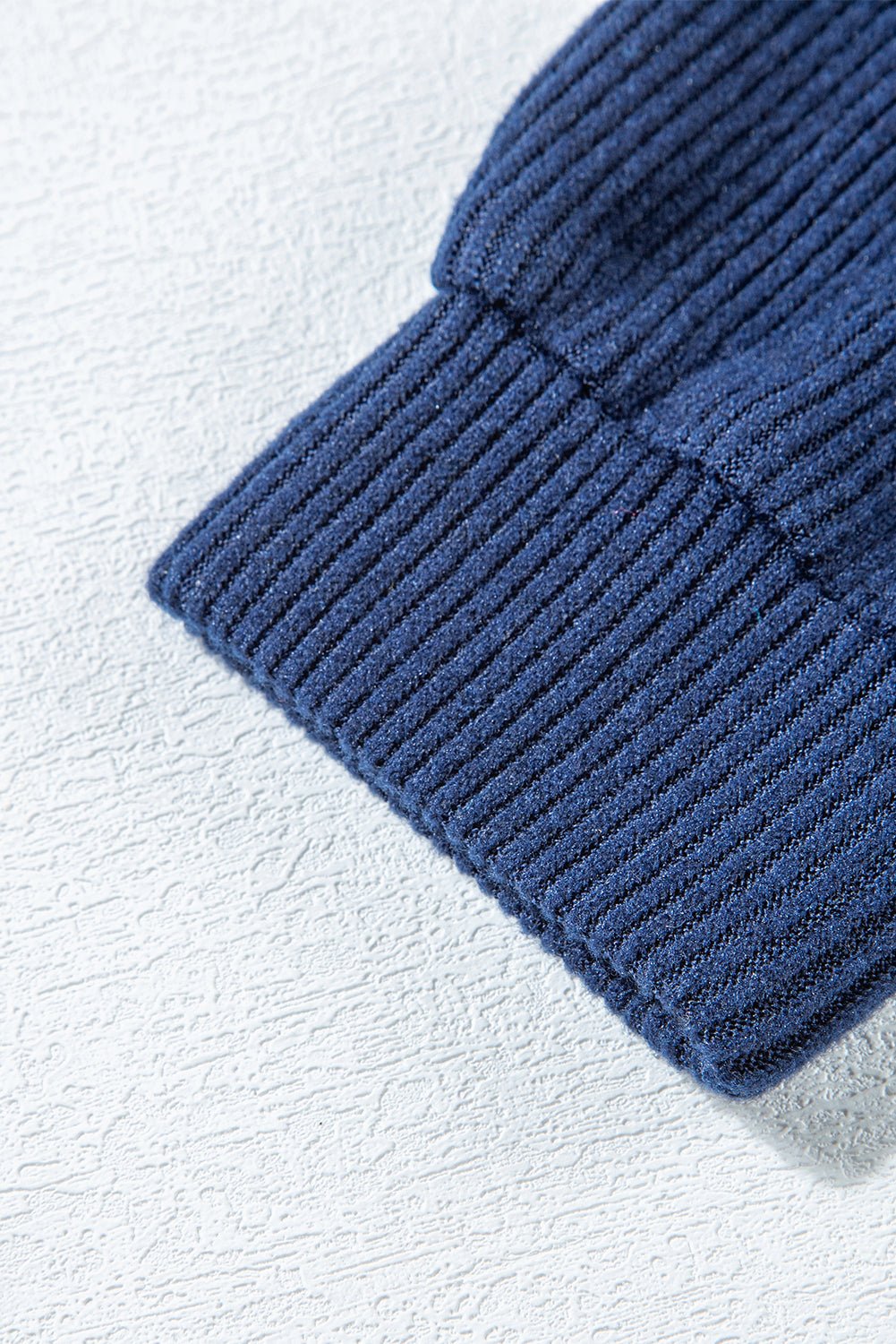 Close-up of a blue textured fabric on a light gray background