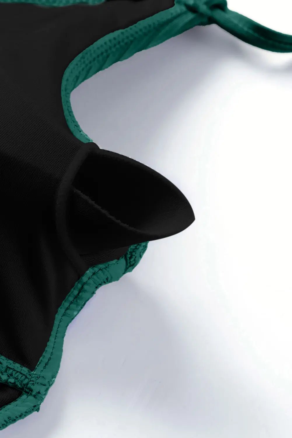 Black and green bikini top on a white background