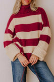 Woman in chunky burgundy-cream striped turtleneck sweater with blue jeans.
