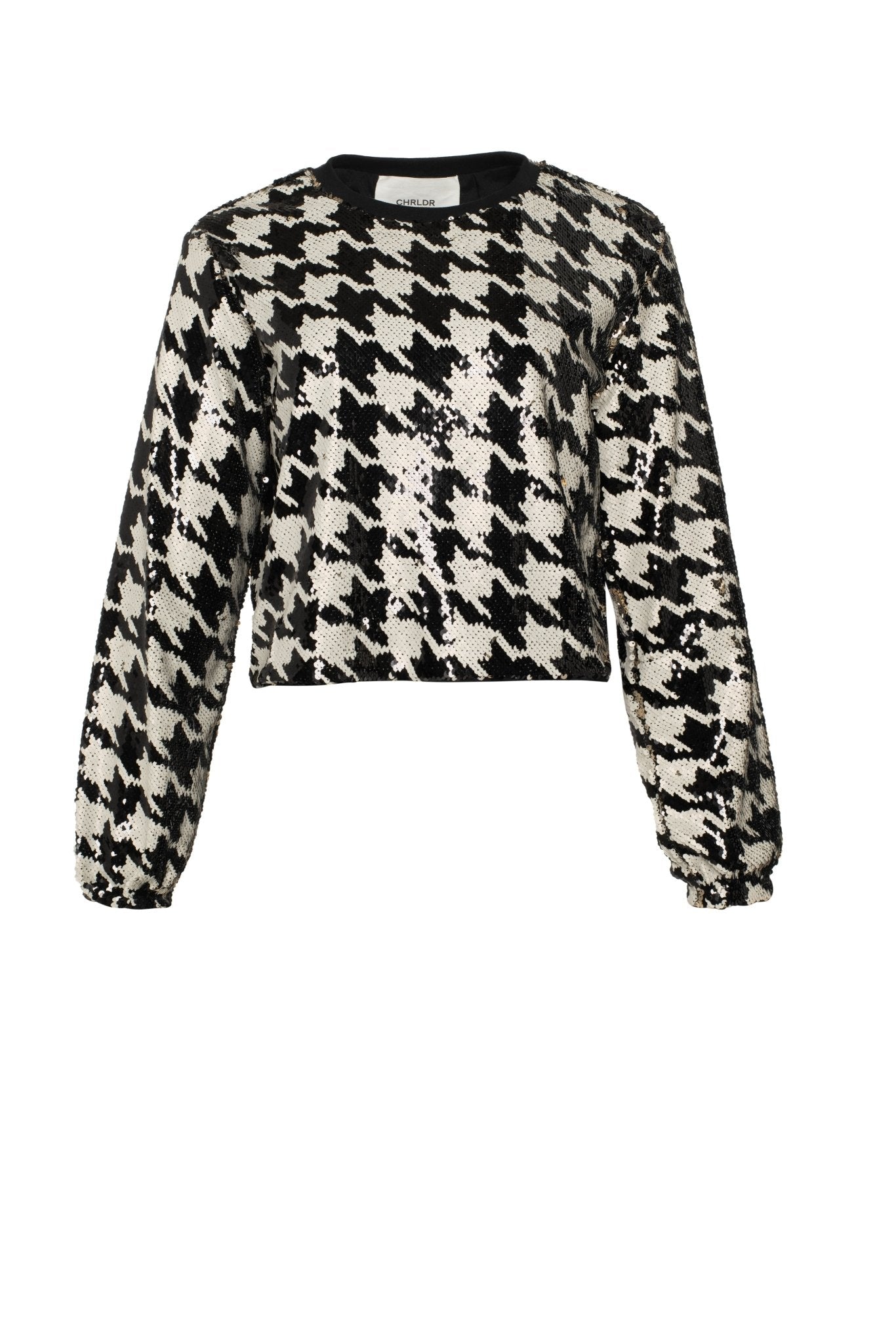 Black and white houndstooth patterned sweater on a white background