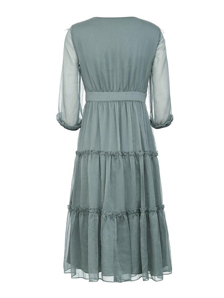 Light blue dress with sheer sleeves on a white background