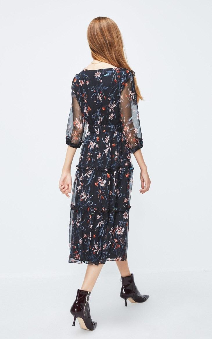 Woman wearing a floral dress on a white background