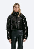 Woman wearing a black sequin jacket on a white background