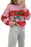 Woman in pink-red striped “holy jolly” sweater with gray sweatpants, mirror selfie.