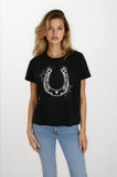 Woman wearing a black t-shirt with a horseshoe design on a white background