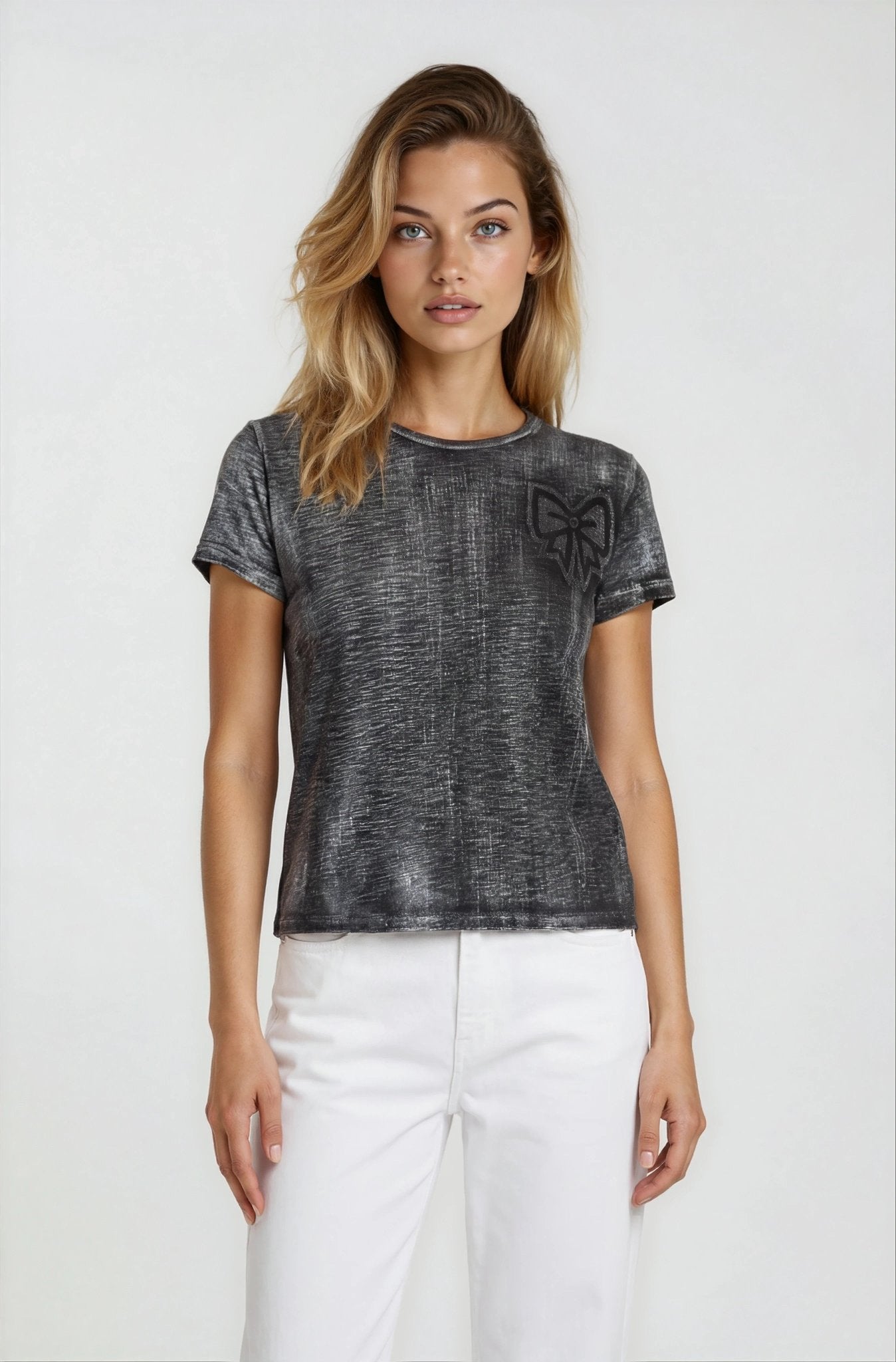 Woman wearing a dark gray t-shirt with a bow design on a white background