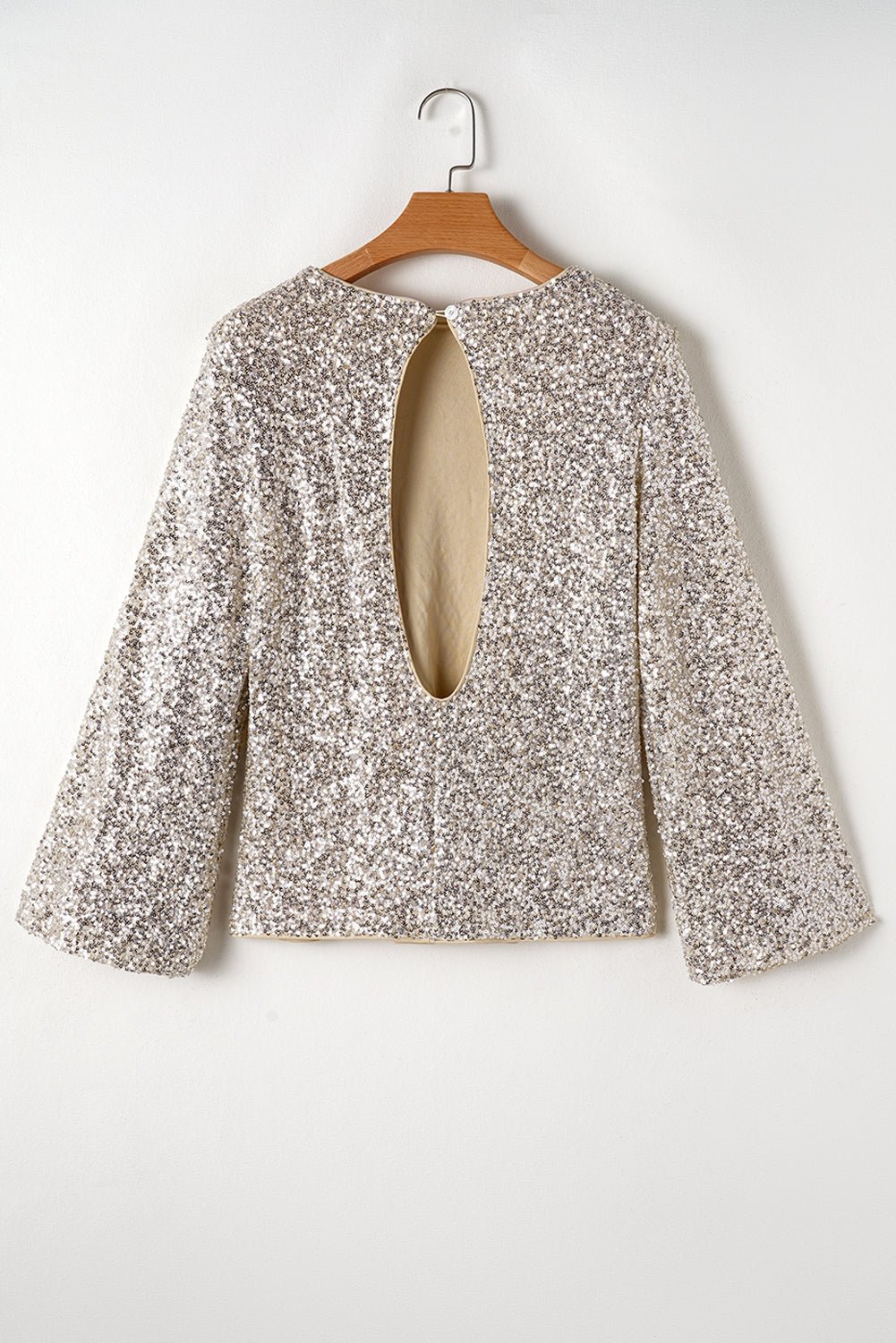 Floral blouse on a wooden hanger against a white background